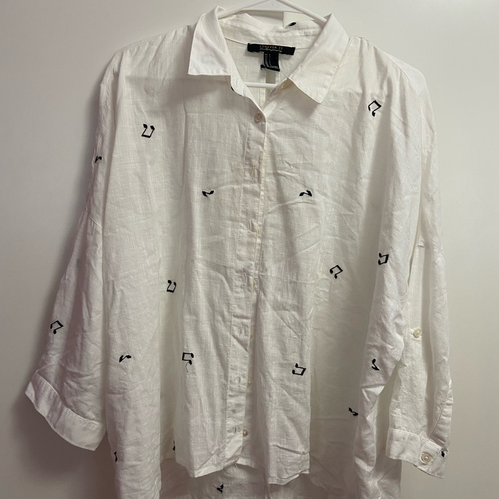 Oversized button down shirt with musical note embroidery.